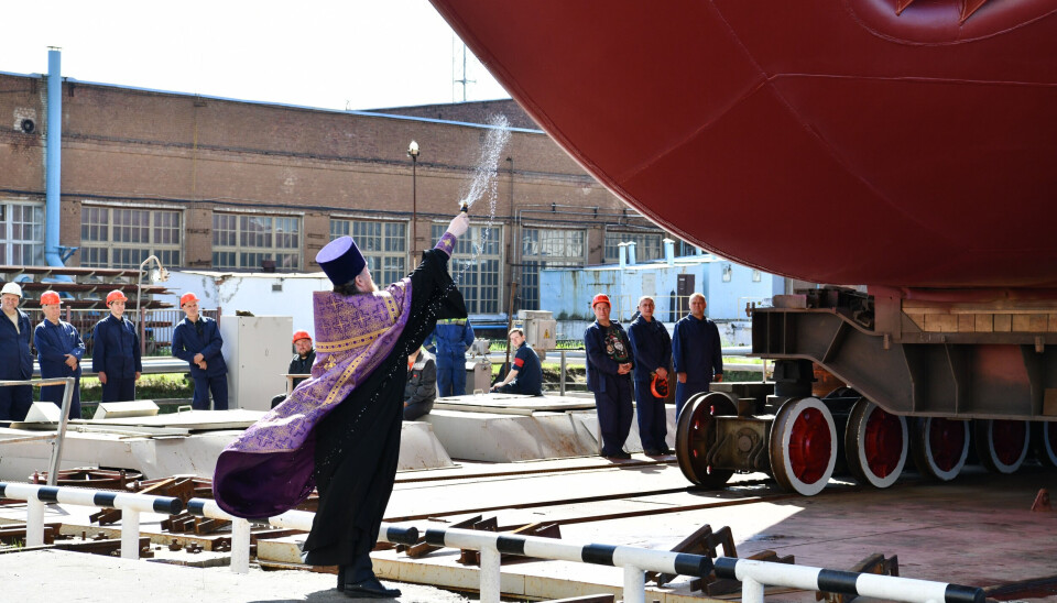 A clergyman blessed the nuclear missile transport ship at the launching ceremony.