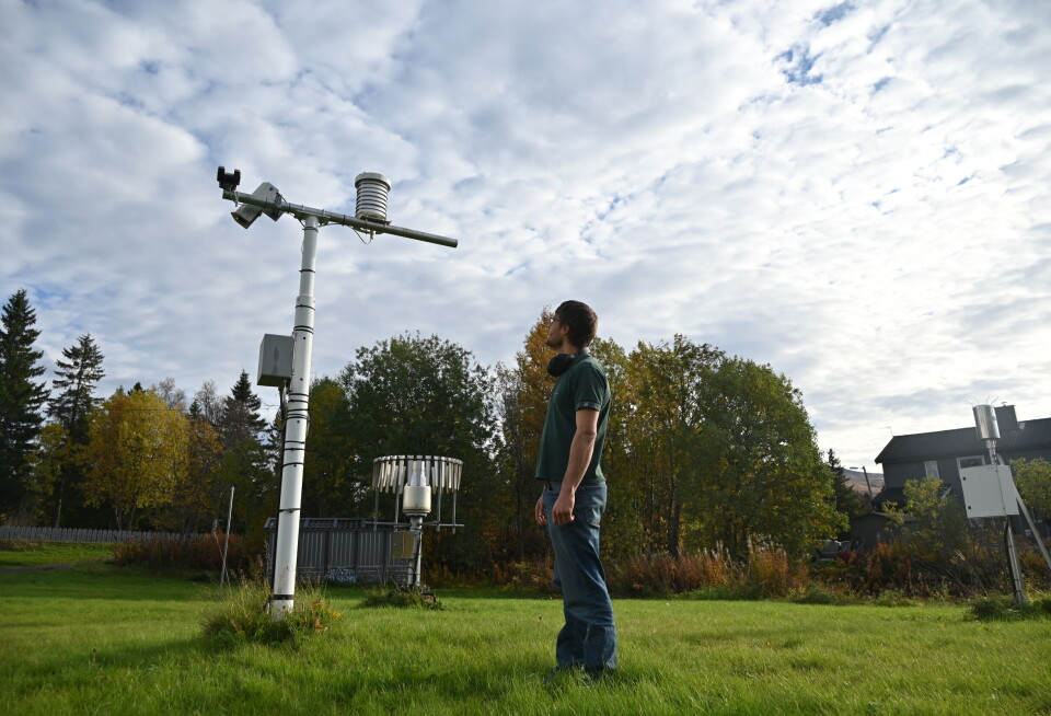 Meteorologist Patrick Stoll standing next to the thermometer in Tromsø, northern Norway
