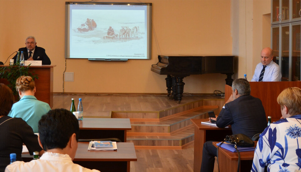 Dudarev (right) holding a lecture about health issues among people living in the North